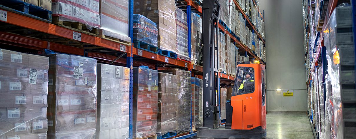 Forklift picking pallet from coldstore shelving